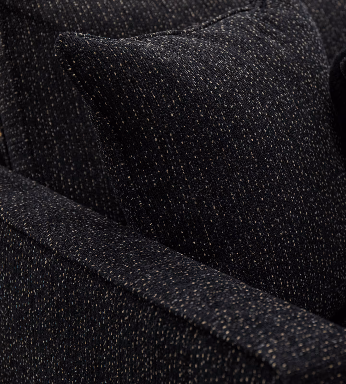 Close-up of custom upholstered sofa arm showing premium fabric texture