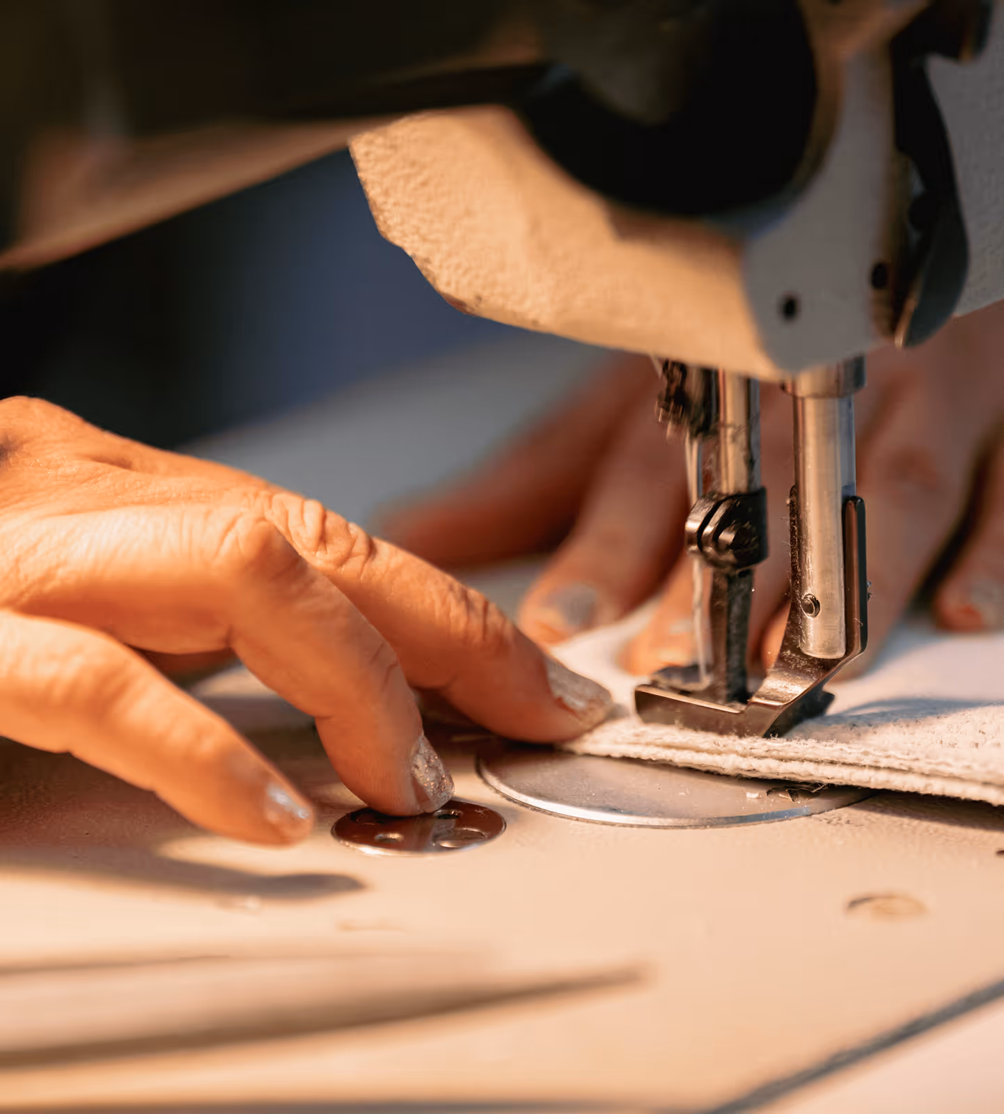 Skilled craftsman sewing furniture upholstery at Living Designs Furniture Houston factory